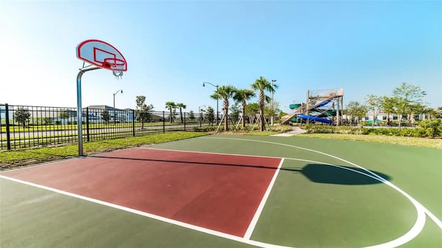 view of basketball court with community basketball court and fence