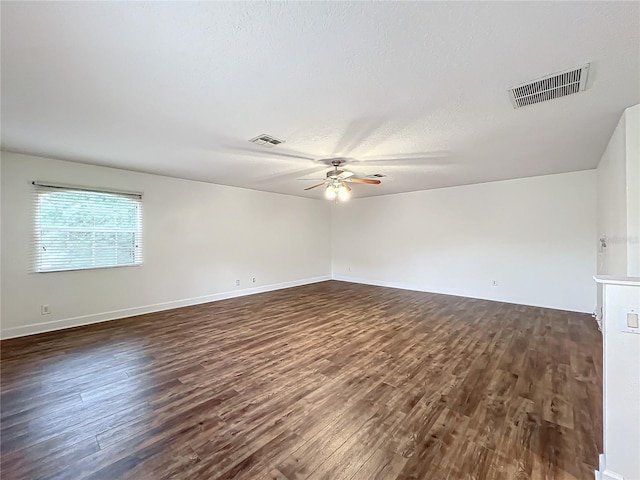 unfurnished room with dark hardwood / wood-style floors, a textured ceiling, and ceiling fan