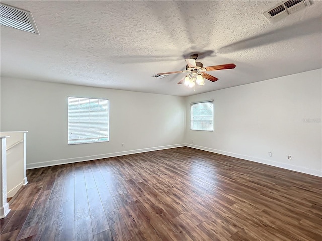 spare room with ceiling fan, dark hardwood / wood-style flooring, and a textured ceiling