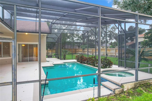 view of swimming pool with an in ground hot tub, a lanai, and a patio