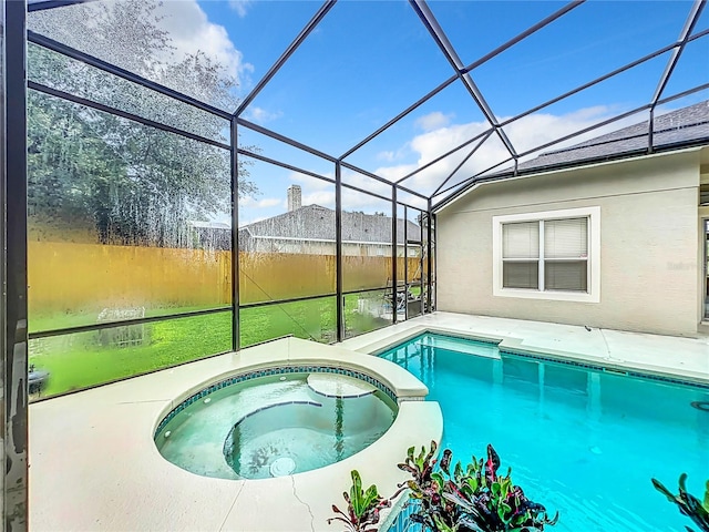 view of pool with an in ground hot tub, a lanai, and a patio area