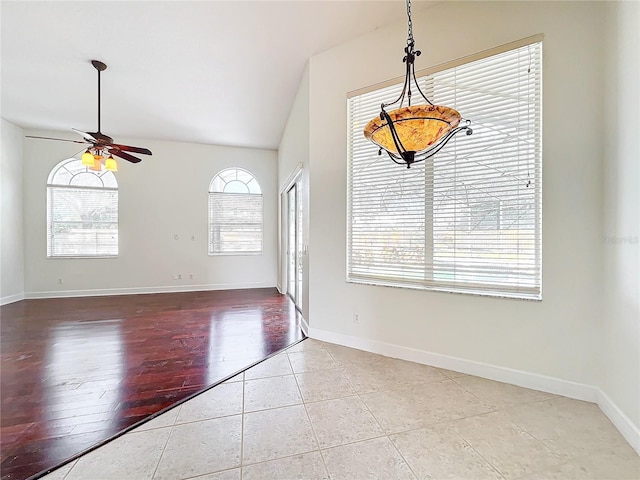 interior space featuring lofted ceiling, light tile patterned floors, a wealth of natural light, and ceiling fan