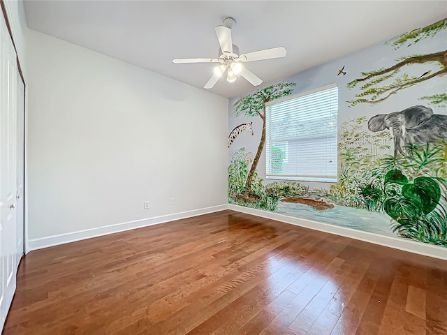 empty room with hardwood / wood-style flooring and ceiling fan