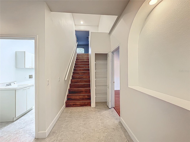 staircase featuring sink