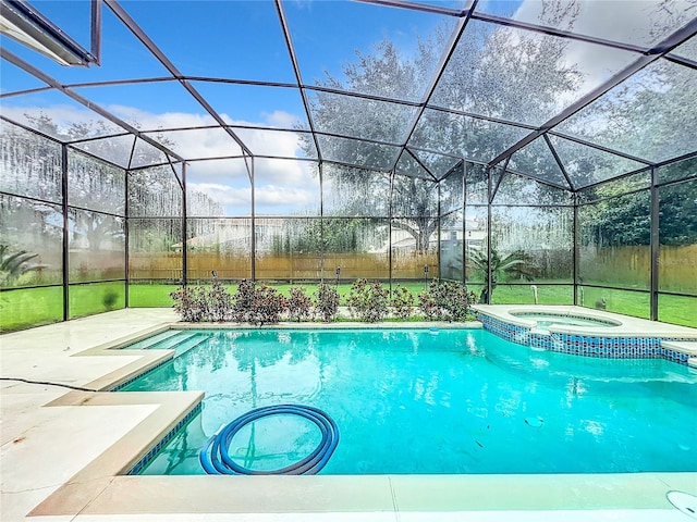 view of pool featuring an in ground hot tub, a patio, and glass enclosure