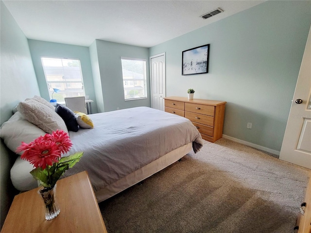 carpeted bedroom with a closet