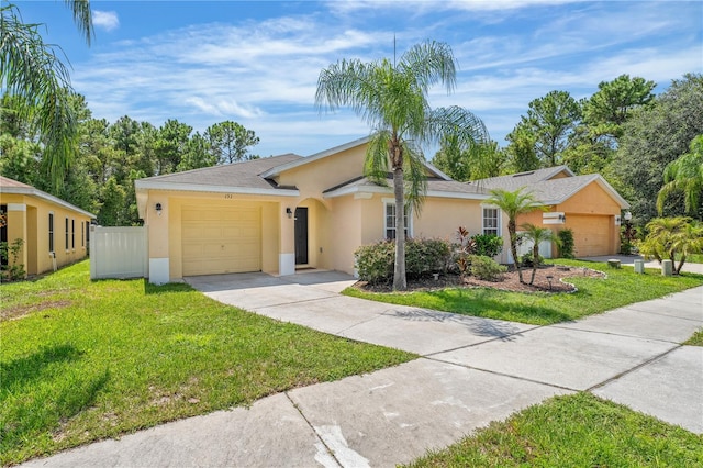 ranch-style home with a front lawn and a garage