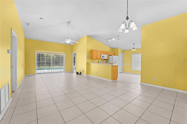 unfurnished living room with lofted ceiling, ceiling fan with notable chandelier, rail lighting, and light tile patterned floors