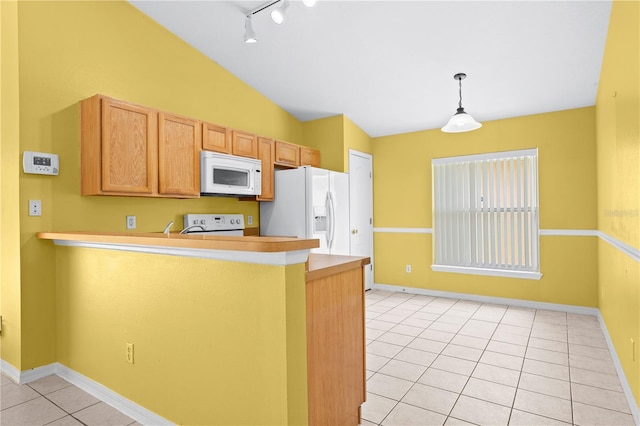 kitchen featuring rail lighting, lofted ceiling, kitchen peninsula, white appliances, and light tile patterned flooring