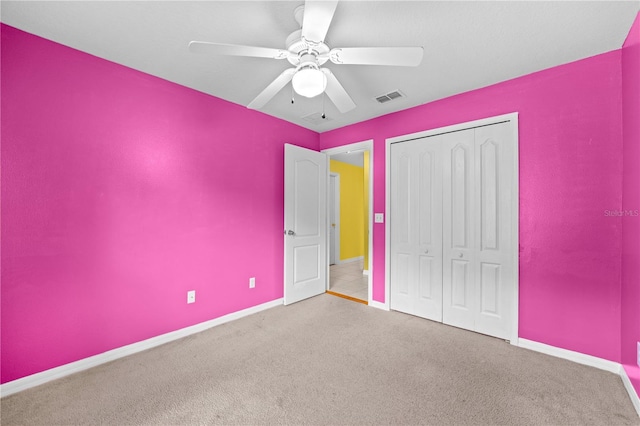 unfurnished bedroom featuring a closet, ceiling fan, and light colored carpet