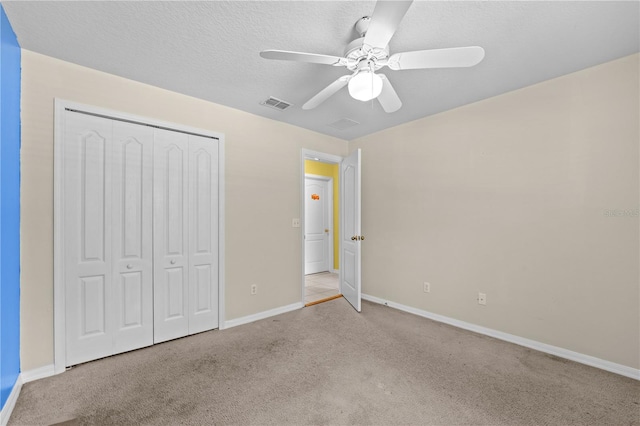 unfurnished bedroom featuring a closet, ceiling fan, and light colored carpet