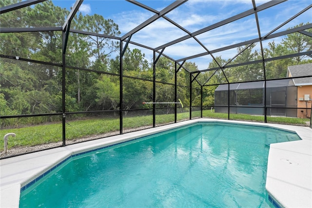 view of pool featuring glass enclosure