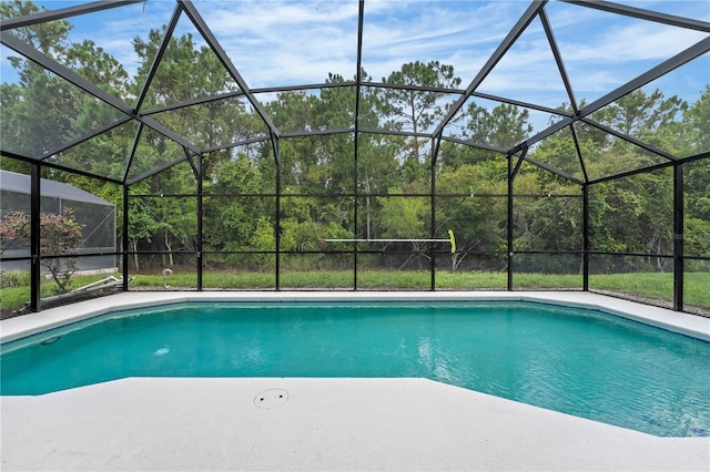 view of swimming pool featuring a lanai