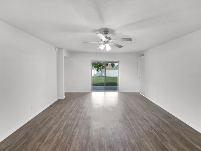 spare room featuring ceiling fan and dark hardwood / wood-style floors