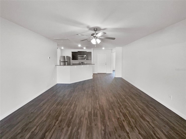 unfurnished living room featuring ceiling fan and dark hardwood / wood-style floors