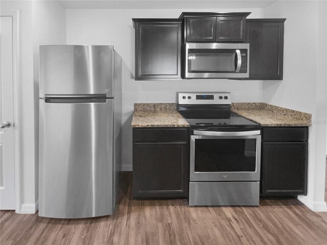 kitchen featuring appliances with stainless steel finishes and wood-type flooring