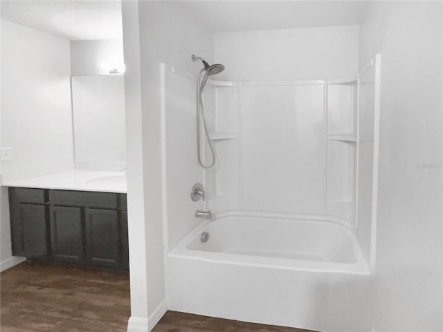 bathroom with bathtub / shower combination, vanity, and wood-type flooring