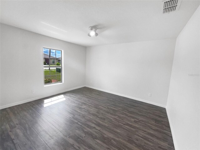 spare room with dark hardwood / wood-style flooring