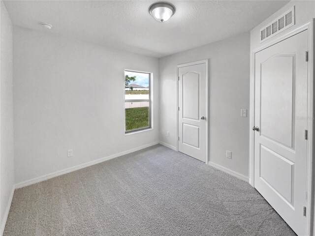 unfurnished room with carpet flooring