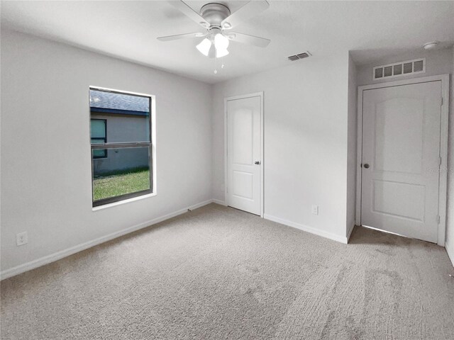 unfurnished room with carpet floors and ceiling fan