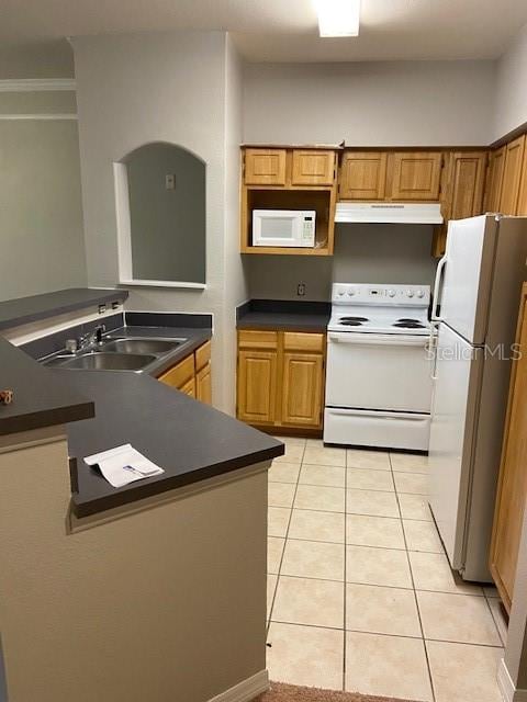 kitchen with sink, white appliances, and light tile patterned floors