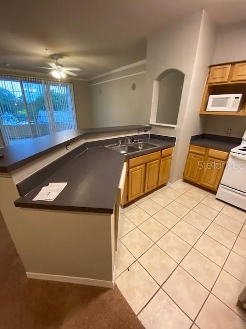 kitchen featuring sink, white appliances, ceiling fan, and light tile patterned floors