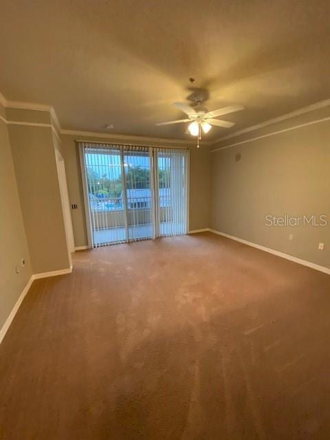 carpeted spare room with ceiling fan and ornamental molding