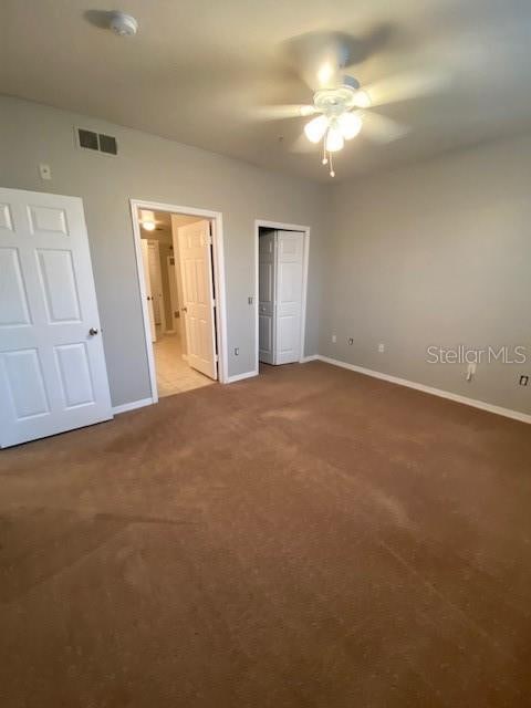 unfurnished bedroom featuring light colored carpet and ceiling fan