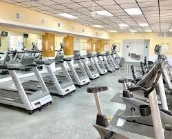 workout area with concrete flooring and a paneled ceiling