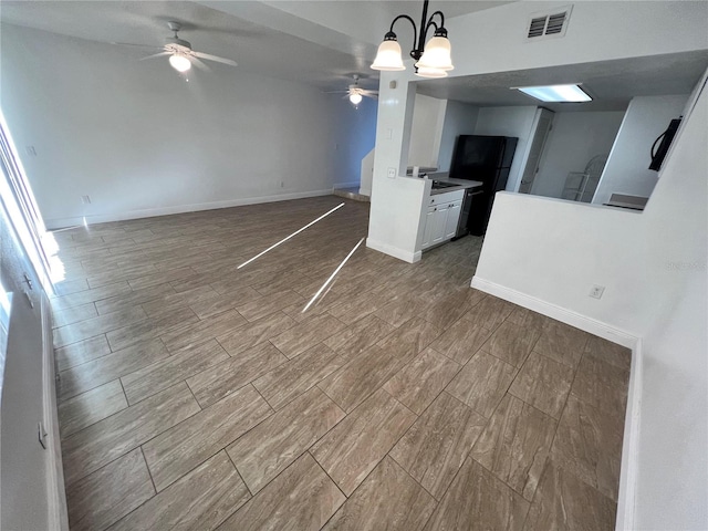 unfurnished living room with ceiling fan, light hardwood / wood-style floors, and sink