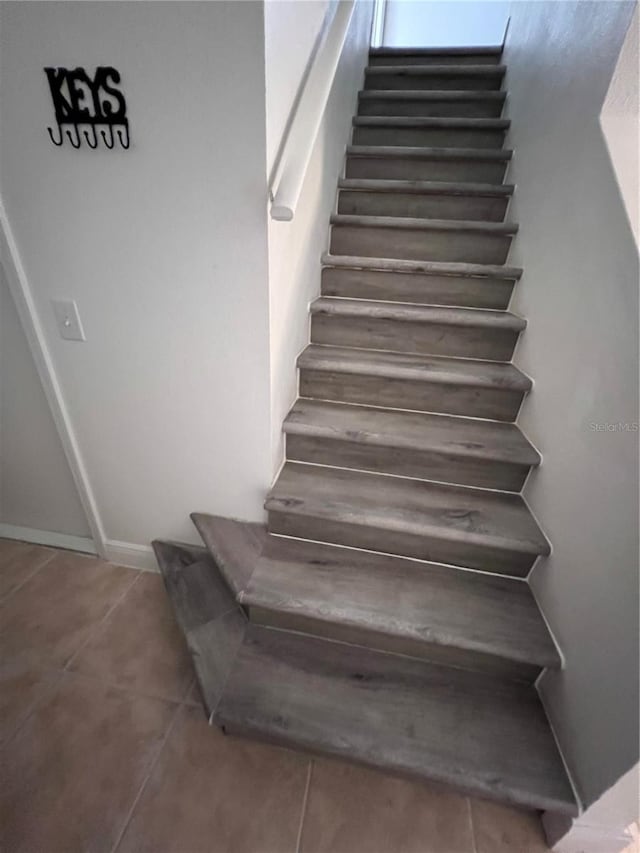 stairway featuring tile patterned floors