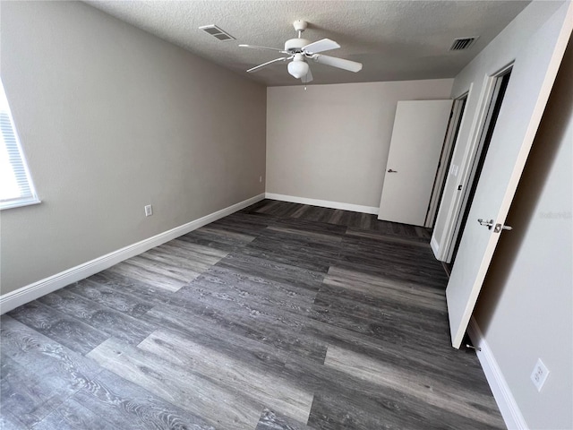 empty room featuring hardwood / wood-style floors, ceiling fan, and a textured ceiling