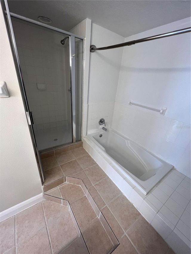 bathroom with tile patterned flooring and separate shower and tub