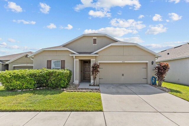 ranch-style house with an attached garage, a front yard, stucco siding, and driveway