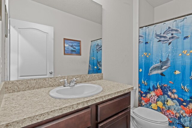 full bath featuring vanity, curtained shower, and toilet