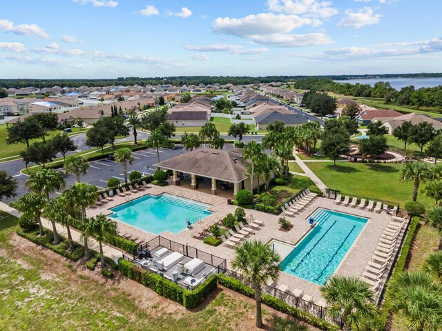 pool with fence and a residential view