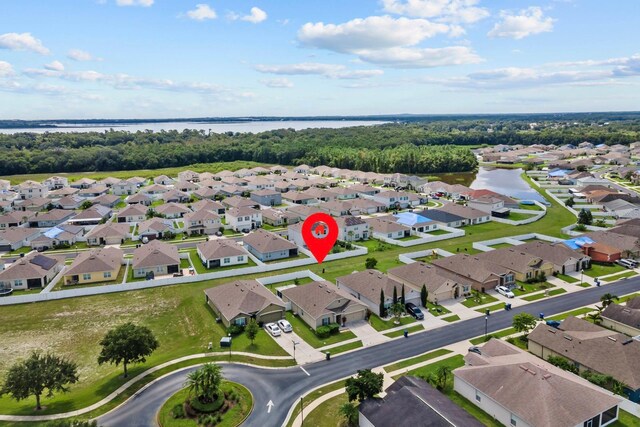 drone / aerial view with a residential view and a water view