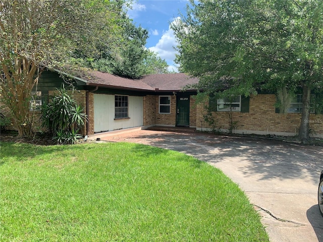 single story home featuring a front yard and brick siding