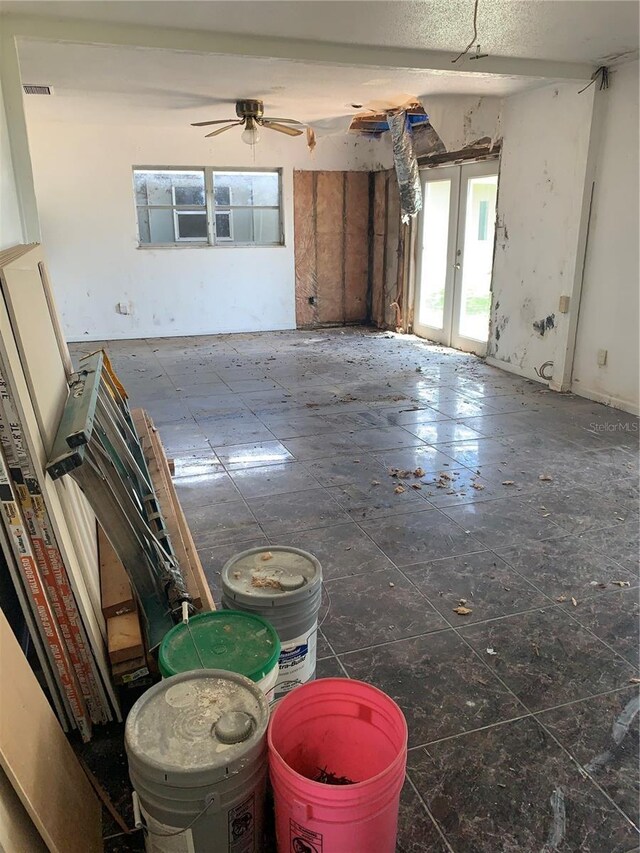 spare room featuring ceiling fan and tile patterned flooring