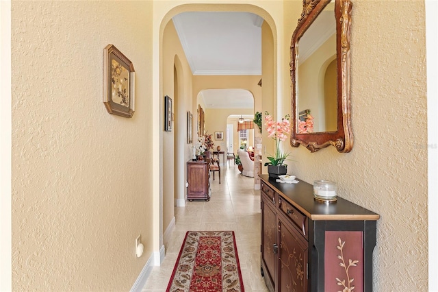 hallway with crown molding and light tile patterned floors