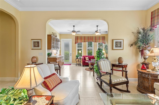 living area with ceiling fan, light tile patterned floors, and crown molding