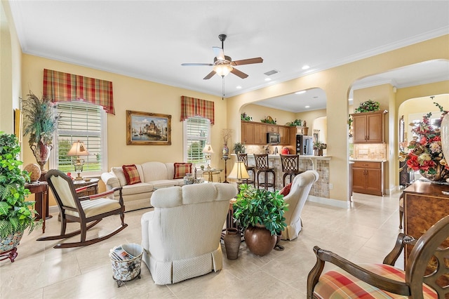 tiled living room with crown molding and ceiling fan