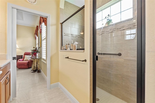 bathroom with vanity, a shower with shower door, and ornamental molding