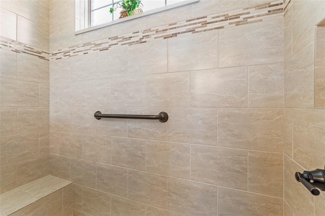 bathroom with a tile shower