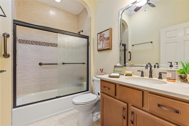 full bathroom with toilet, tile patterned floors, vanity, ceiling fan, and enclosed tub / shower combo