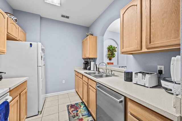 kitchen with dishwasher, sink, light brown cabinets, light tile patterned floors, and stove