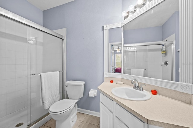 bathroom featuring tile patterned floors, toilet, an enclosed shower, and vanity