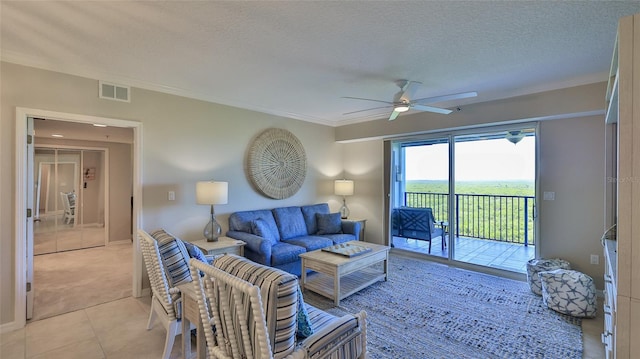 tiled living room with ceiling fan and a textured ceiling