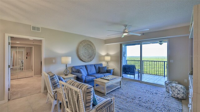 5300 S Atlantic Ave Unit 16-602, New Smyrna Beach, FL 32169 - living area with ceiling fan, a textured ceiling, crown molding, light tile patterned floors, and light colored carpet