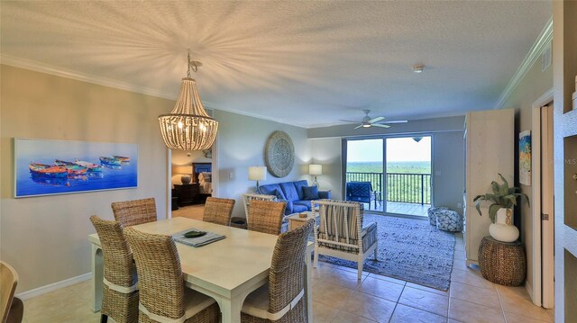 5300 S Atlantic Ave Unit 16-602, New Smyrna Beach, FL 32169 - dining room with a chandelier, ceiling fan, ornamental molding, light tile patterned floors, and a textured ceiling